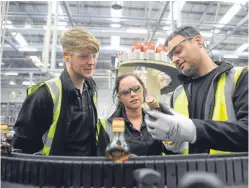  ??  ?? Apprentice­s David Paterson and Letitia Miller with Mark Combe at Diageo, Leven.