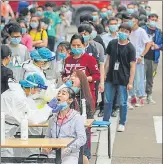  ?? AFP ?? ■
Wuhan residents queue up to give swab samples for Covid-19 testing on Friday. City authoritie­s are on a mission to test 8mn residents.