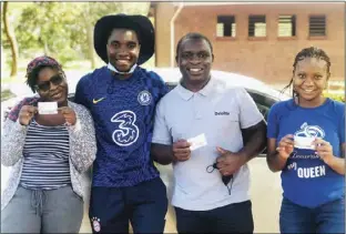  ?? ?? Freddy Michael Masarirevu (second from left) after helping potential voters to register to vote at Nettleton Primary School in Harare yesterday. He also provided them with transport.