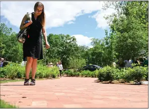  ?? (Arkansas Democrat-Gazette/Stephen Swofford) ?? Stephanie Rose finds her name on an alumni brick during a cermony to unveil the Alumni Patio outside the Bailey Alumni and Friends Center on the University of Arkansas at Little Rock campus on Friday.