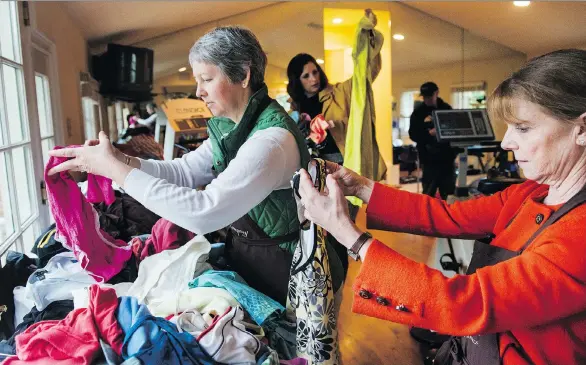  ?? AMANDA VOISARD/THE WASHINGTON POST ?? If you’re the least bit modest wear something fitted, such as leggings, when trying on various clothing items at an estate sale.