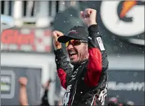  ?? MATT SLOCUM/AP PHOTO ?? Martin Truex Jr. celebrates after winning the NASCAR Monster Cup race on Sunday at Watkins Glen, N.Y.