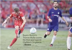  ?? — Reuters ?? Bayern Munich’s Thomas Muller scores the third goal against Chelsea in Singapore.