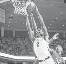  ?? Scott Morgan / Associated Press ?? Iowa State’s Cameron Lard, left, grabs a rebound over Texas Tech’s Norense Odiase during the second half of Saturday’s game in Ames, Iowa.