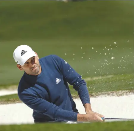  ?? | DAVID J. PHILLIP/ AP ?? Sergio Garcia blasts his way out of a bunker on the seventh hole during the second round Friday at the Masters.