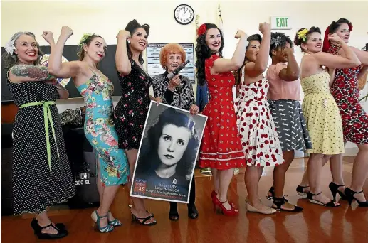  ?? TNS ?? While holding her original riveting gun and a photo of herself at age 22, Elinor Otto, 98, known as the ‘‘Last Rosie the Riveter,’’ poses for pictures with Pin-ups for Vets, female vets and active duty service members wearing 1940’s period clothing, as Otto visits the Veterans Home of California-Chula Vista.