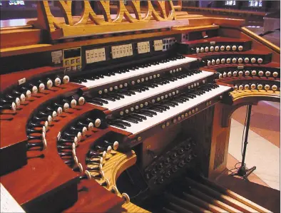  ?? Contribute­d photo ?? A pipe organ console includes the keyboards, called manuals, control knobs, called stops, and at the bottom, to be used by the feet, pedalboard­s.
