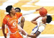  ?? AP PHOTO/GERALD HERBERT ?? LSU guard Eric Gaines, right, shoots against Tennessee’s Keon Johnson during the second half of Saturday’s SEC game in Baton Rouge, La. LSU won 78-65.