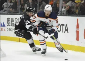  ?? MARK J. TERRILL - THE ASSOCIATED PRESS ?? Edmonton Oilers center Connor McDavid, right, moves the puck while under pressure from Los Angeles Kings defenseman Sean Walker during the third period of an NHL hockey game Sunday, Feb. 23, 2020, in Los Angeles. The Oilers won 4-2.