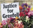  ??  ?? Flowers and messages calling for justice have been left outside Grenfell Tower