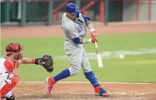  ?? AP ?? The Cubs’ Javy Baez hits the first of his two home runs Wednesday against the Reds. He had a solo shot in the seventh inning and a two-run blast in the ninth.