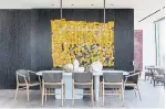  ??  ?? A wall hanging in the dining area was made by Ghanaian artist Serge Attukwei Clottey from pollution, such as plastic water containers.