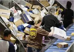  ?? Employees sort packages at the United Parcel Service, Inc. (UPS) Chicago Area Consolidat­ion Hub in Hodgkins, Illinois, US. (Bloomberg) ??