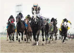  ?? NATHAN DENETTE ?? Mighty Heart, with jockey Daisuke Fukumoto, rides to victory during the running of the 161st Queen’s Plate in September. The 2021 race will be held in August due to the pandemic.