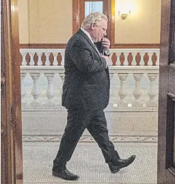  ?? FRANK GUNN THE CANADIAN PRESS FILE PHOTO ?? Premier
Doug Ford arrives for a press briefing in Toronto on Feb. 8. Bill Templeman questions the premier’s motivation­s in some of the decisions made during the pandemic.