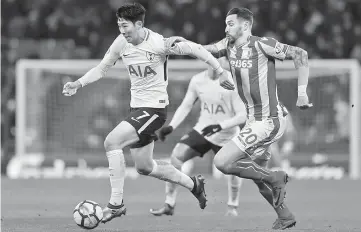  ??  ?? Tottenham Hotspur’s South Korean striker Son Heung-Min vies with Stoke City’s US defender Geoff Cameron during the English Premier League football match between Tottenham Hotspur and Stoke City at Wembley Stadium in London. — AFP photo