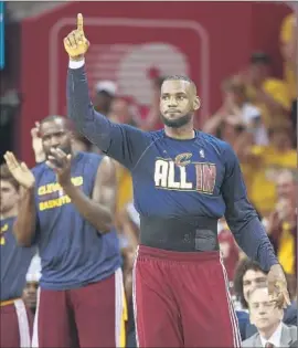  ?? Ron Schwane
Associated Press ?? LeBRON JAMES WAS ABLE to spend the final moments of the Eastern Conference finals sweep of Atlanta cheering on his teammates from the sidelines.