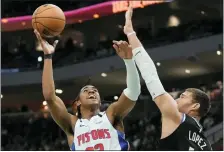  ?? MORRY GASH — THE ASSOCIATED PRESS ?? Detroit Pistons guard Jaden Ivey (23) shoots past Milwaukee Bucks center Brook Lopez (11) during the first half of Monday’s game in Milwaukee.