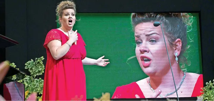  ?? ?? Pendine’s Voice of the Future at Llangollen Eisteddfod presented by Eisteddfod’s Terry Waite. Pictured: Winner Erin Rossington from North Wales performing in 2019