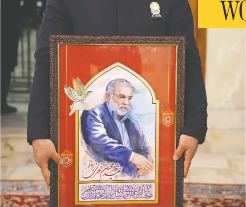  ?? IRANIAN DEFENCE MINISTRY / AFP via Gett y Imag es ?? A painting of Iran’s assassinat­ed top nuclear scientist Mohsen Fakhrizade­h is carried during his funeral procession
in the city of Mashhad on Sunday. Iran’s clerical and military rulers have blamed Israel for the killing.