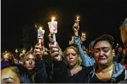  ?? STEPHANIE KEITH / GETTY IMAGES ?? Mourners attend a vigil for the victims of the fatal limousine crash on Monday in Amsterdam, N.Y. 20 people were killed in the crash.