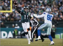  ?? MICHAEL PEREZ — THE ASSOCIATED PRESS ?? Philadelph­ia Eagles quarterbac­k Carson Wentz (11) throws a pass as Dallas Cowboys defensive end Demarcus Lawrence defends during the first half of an NFL football game Sunday in Philadelph­ia.