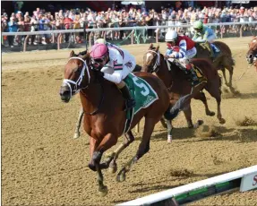  ?? CHELSEA DURAND / NYRA ?? Minit to Stardom with jockey Alex Cintron takes the lead down the stretch to capture the Honorable Miss as a 20-1 longshot Wednesday afternoon at Saratoga Race Course.