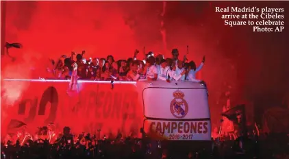  ??  ?? Real Madrid’s players arrive at the Cibeles Square to celebrate Photo: AP