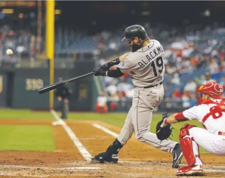  ??  ?? Rockies center fielder Charlie Blackmon hits a two-run homer off Philadelph­ia starting pitcher Zach Eflin during the third inning Tuesday night as Phillies catcher Andrew Knapp watches. Blackmon homered again in the fourth inning. Matt Slocum, The Associated Press