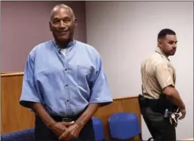  ?? JASON BEAN — THE RENO GAZETTE-JOURNAL VIA AP ?? Former NFL football star O.J. Simpson enters for his parole hearing at the Lovelock Correction­al Center in Lovelock, Nev., on Thursday. Simpson was convicted in 2008 of enlisting some men he barely knew, including two who had guns, to retrieve from two...