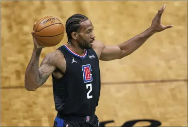  ?? JACOB KUPFERMAN — THE ASSOCIATED PRESS FILE ?? In this May 31, 2021, file photo, Los Angeles Clippers forward Kawhi Leonard looks to pass the ball during the team’s NBA basketball game against the Charlotte Hornets in Charlotte, N.C. Leonard is staying in Los Angeles after the Clippers re-signed him. Leonard sustained a partially torn right ACL during the recent playoffs, and missed the Clippers’ run to their first Western Conference finals appearance. He had surgery on his knee a month ago.