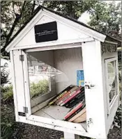  ?? MICHAEL E. MILLER/WASHINGTON POST PHOTOS ?? This Little Free Library dedicated to Michelle Obama has been vandalized several times. Above, the glass and door were broken. Later, vandals wrote Trump’s name on it.