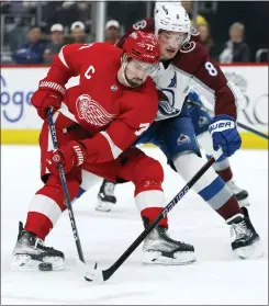  ?? DUANE BURLESON — THE ASSOCIATED PRESS ?? Detroit Red Wings center Dylan Larkin (71) has the puck knocked away by Colorado Avalanche defenseman Cale Makar (8) during the third period of Saturday’s game in Detroit.