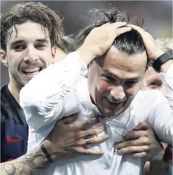  ??  ?? Croatia head coach Zlatko Dalic celebrates with Sime Vrsaljko (left) after his team advanced to the World Cup final.