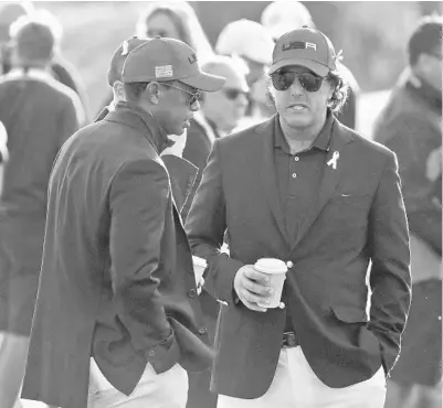  ?? AP FILE ?? Tiger Woods and Phil Mickelson, seen above at the closing ceremony of the last Ryder Cup, won’t be playing this week at Whistling Straits.