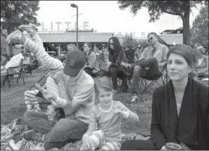  ?? Arkansas Democrat-Gazette/BENJAMIN KRAIN ?? Elizabeth and Aaron Clark entertain their daughters, Louise (left) and Liza, during a community Easter Sunrise Service at Riverfront Park in Little Rock on Sunday.