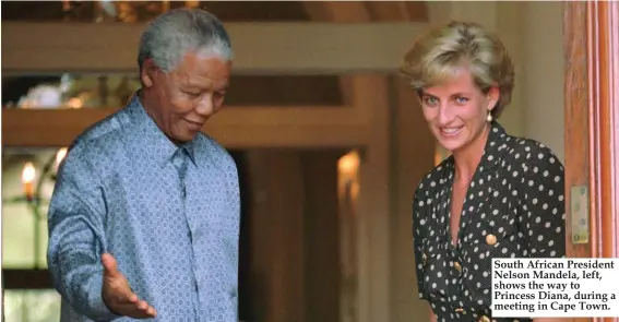  ??  ?? South African President Nelson Mandela, left, shows the way to Princess Diana, during a meeting in Cape Town.