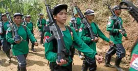  ??  ?? ARMED Young communist rebels patrol the countrysid­e.
