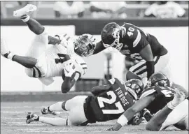  ?? TODD HARRIS JR. Sean Gardner Getty Images ?? of Louisiana State is tackled by Esaias Furdge of Mississipp­i State. LSU is the first defending national champion to lose its opener since 1998.