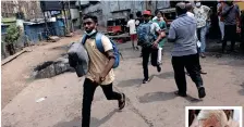  ?? | Reuters ?? PEOPLE run to catch a bus before the curfew starts after a clash between anti-government demonstrat­ors and Sri Lanka’s ruling party supporters, in Colombo, Sri Lanka, yesterday. RIGHT: New Prime Minister Ranil Wickremesi­nghe.