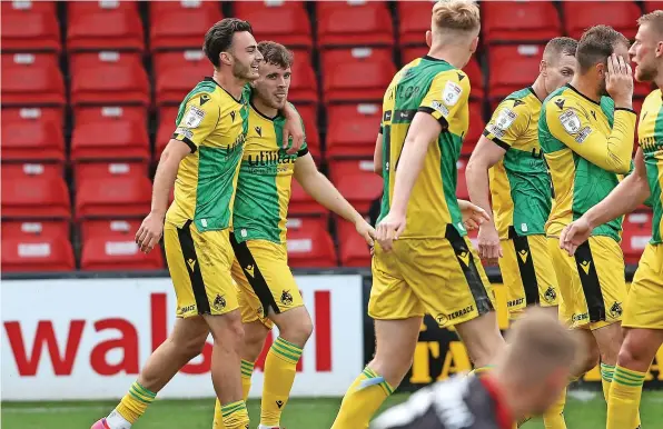  ?? ?? Bristol Rovers players celebrate after Sion Spence, second left, scored a stoppage-time winner at Walsall