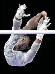  ?? Thomas Kienzle / AFP via Getty Images ?? Simone Biles’ fifth all-around world crown included a third-place finish on the uneven bars.