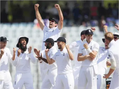  ??  ?? CHITTAGONG: England’s captain Alastair Cook (top 3rd L) celebrates with teammates after beating Bangladesh during the final day’s play of the first Test cricket match at Zahur Ahmed Chowdhury Cricket Stadium in Chittagong yesterday. — AFP