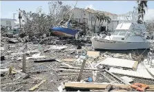  ?? CHIP SOMODEVILL­A/GETTY IMAGES ?? Boats, cars and other debris clog waterways in the Florida Keys on Wednesday in the wake of hurricane Irma. Irma is expected to incur one of the biggest losses from a storm in history, estimated at US$20 billion to US$65 billion.