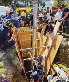  ?? Stony Hill Volunteer Fire Company / Contribute­d photo ?? Crews work to rescue a worker trapped in a trench collapse in Bethel on Wednesday. The man was later transporte­d by helicopter to a hospital for treatment.