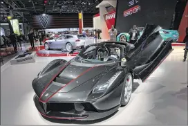  ?? CHRISTOPHE ENA / AP ?? Ferrari’s LaFerrari Aperta is on display at the Paris Auto Show in Paris on Friday. This limited-edition supercar sold out at prices of $2 million and up .