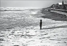  ?? FRANCIS R. MALASIG/EPA ?? Typhoon hits Philippine­s: A Filipino woman prays for protection from Super Typhoon Haima. Haima slammed into the northeaste­rn Philippine coast Wednesday with ferocious winds and rain that rekindled memories of catastroph­ic Typhoon Haiyan in 2013.