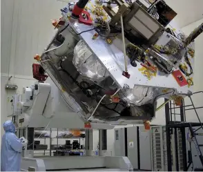  ??  ?? Just after having had its radiation vault fitted over its propulsion module, Juno is lifted on a rotation fixture at Lockheed Martin Space Systems, Denver in June 2010