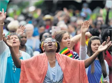  ?? AFP/Getty Images ?? ZIMBABWEAN­S hold a prayer rally in Harare, the capital. Tens of thousands of Zimbabwean­s have called for President Robert Mugabe’s ouster, but he said he would preside over the ruling party congress in December.