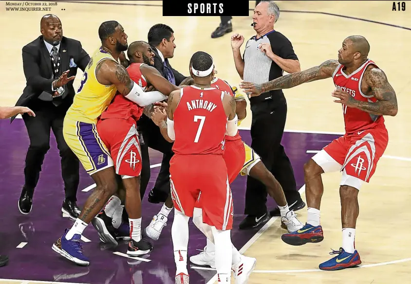  ?? —AP ?? MONDAY / OCTOBER 22, 2018 WWW.INQUIRER.NET Houston Rockets’ Chris Paul (second from left) is held back by Los Angeles Lakers’ LeBron James (left) as Paul tries to attack Lakers’ Rajon Rondo (hidden) during the second half of their game on Saturday.